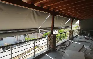Awnings with side arms and anthracite fabric