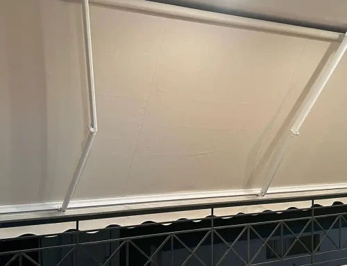 Awnings with Somfy motor arms and off-white fabric